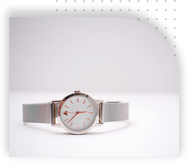 A white and silver watch sitting on top of a table.