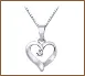 A heart shaped pendant with an initial on it.